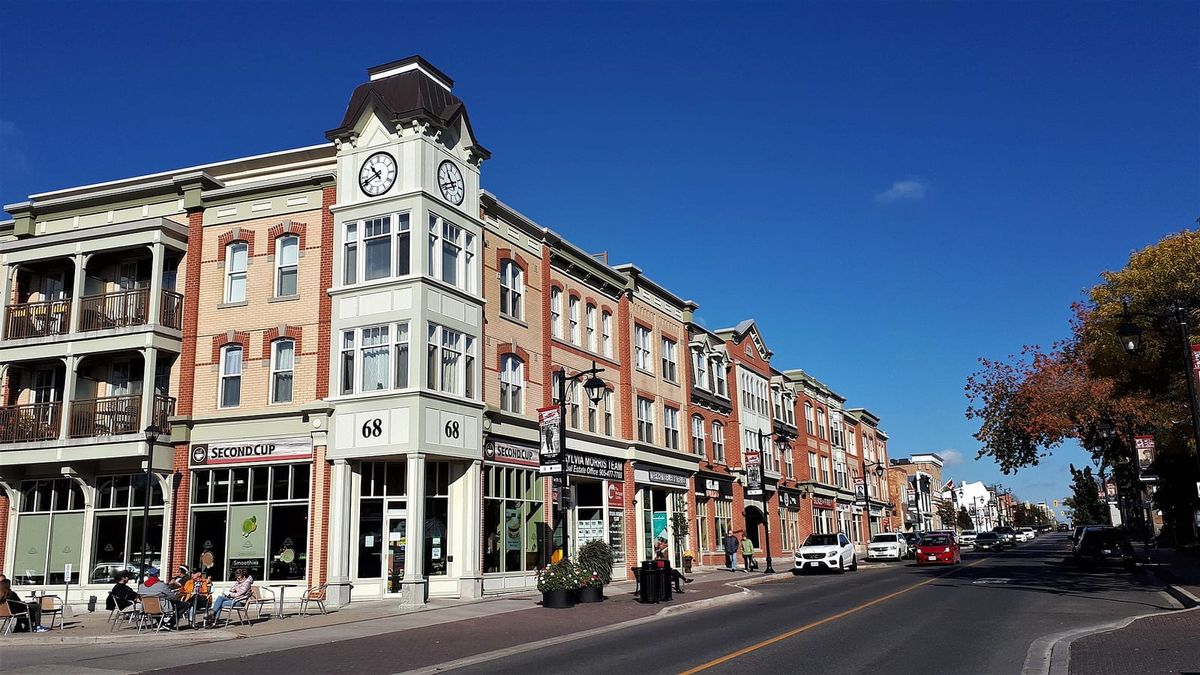 Heritage-style shops and a clock tower building along Main Street in Markham Village.
